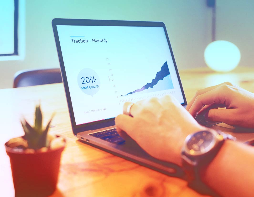 Laptop showing a monthly traction chart during a review